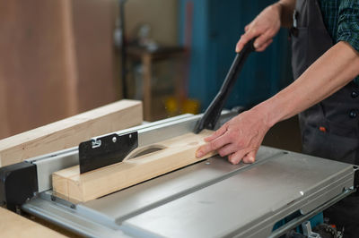 Midsection of man working in workshop