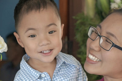 Close-up of cheerful mother and son