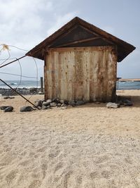 House on beach against sky