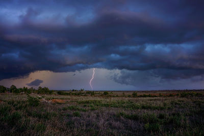 Late afternoon storm with black clouds and lightning in outback queensland.
