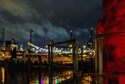 Illuminated factory against sky at night