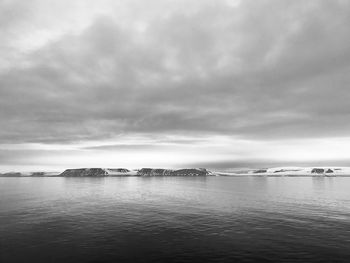 Arctic coastline under the midnight sun and a cloudy sky