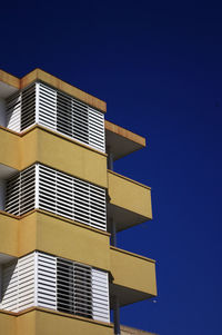 Low angle view of building against blue sky