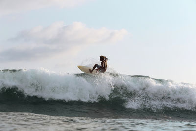 Surfer on a wave, lombok, indonesia