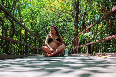 Woman sitting on a tree