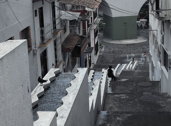 High angle view of footpath amidst buildings in town