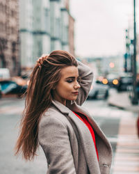 Beautiful woman standing on street in city