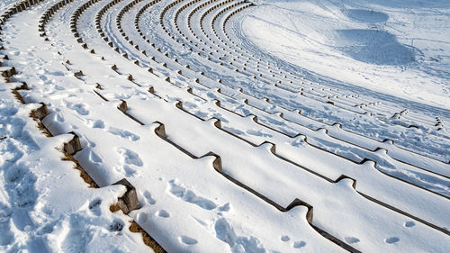 High angle view of tire tracks on snow covered land