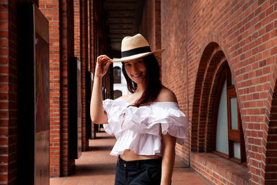 Beautiful young woman wearing a traditional hat from aguadas in colombia called an aguadeño hat.