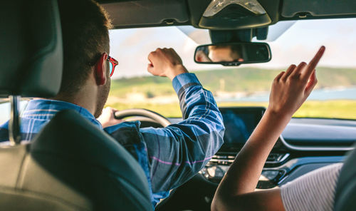 Young couple driving car