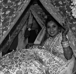 Portrait of young woman lying on bed