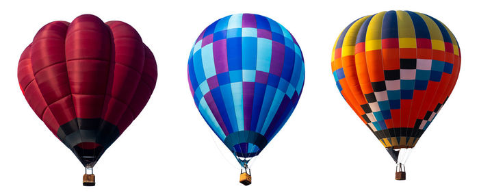 Low angle view of hot air balloons over white background