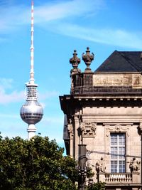 Low angle view of building and fernsehturm against sky