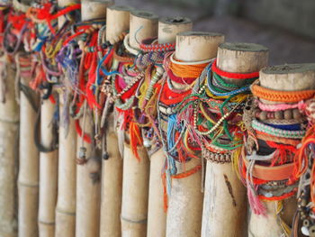 Close-up of multi colored objects tied on bamboos