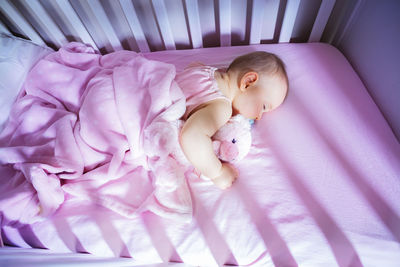 High angle view of baby boy sleeping on bed