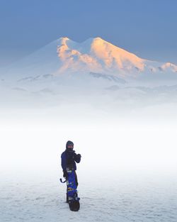 Man standing on mountain against sky