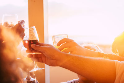 Close-up of hands toasting drinks