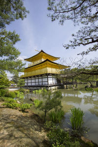 Temple by building against sky
