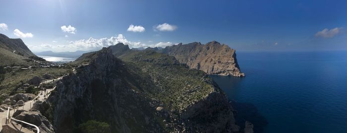 Panoramic view of sea and mountains against sky