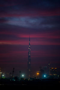 Low angle view of illuminated buildings against sky at sunset