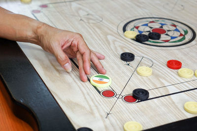 Cropped hand playing carrom