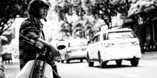 Man riding bicycle on street in city