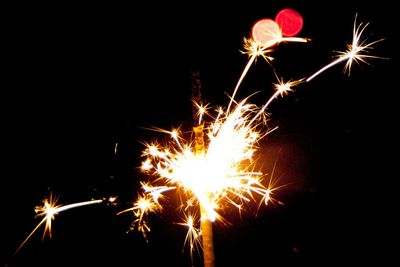 Low angle view of firework display at night