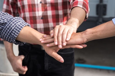 Close-up of men with stacked hands