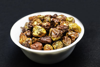 Close-up of food served on table against black background