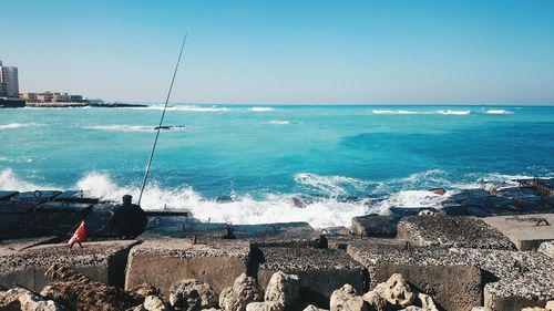 Scenic view of sea against clear blue sky