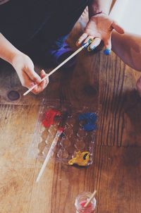 High angle view of person painting on table