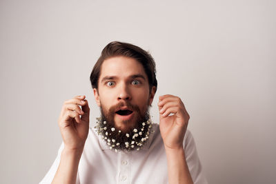 Portrait of young man against white background