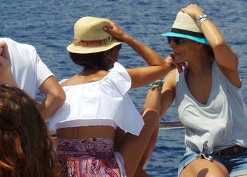 Friends sitting on boat in sea during summer