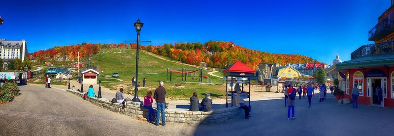 View of multi colored town against clear blue sky