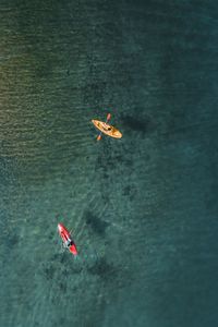 Aerial view of people kayaking in sea