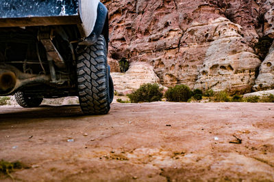 Rear view of a truck on road along rocks