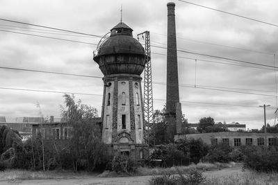 View of water tower against cloudy sky