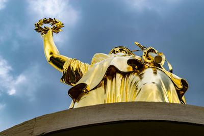 Low angle view of statue against sky