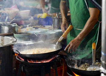 Midsection of man preparing food