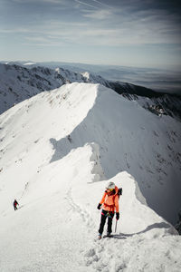 People skiing on snowcapped mountain