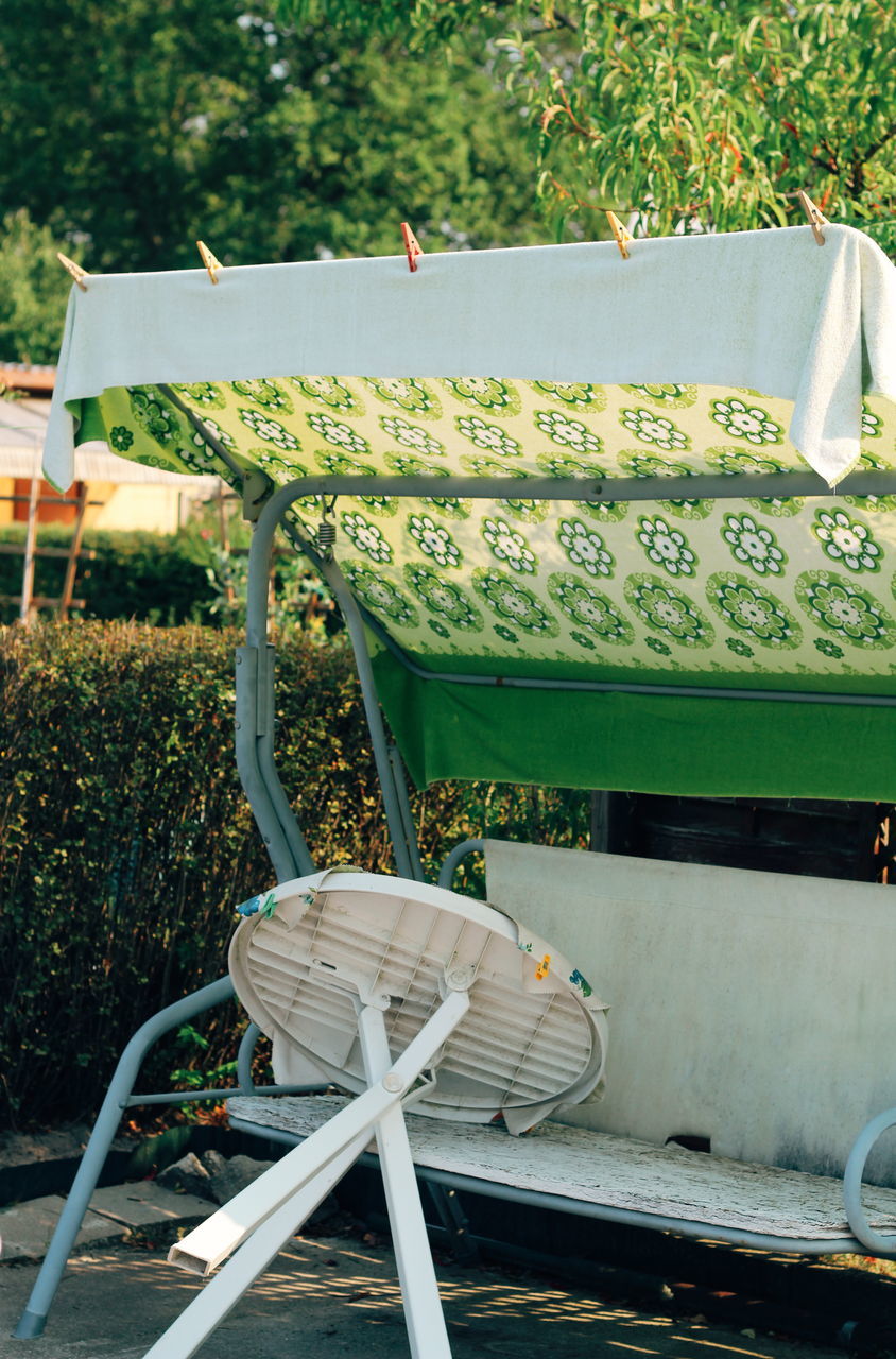 EMPTY CHAIRS AND TABLE IN YARD