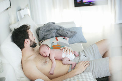 Mid adult man with newborn baby