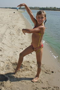 Portrait of happy girl standing on beach