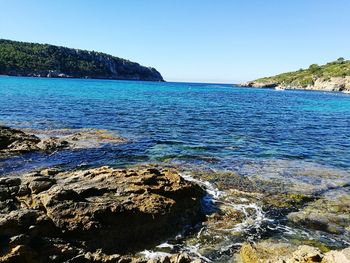 Scenic view of sea against clear blue sky