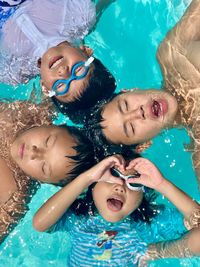 Portrait of happy girl in swimming pool