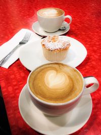 Close-up of cappuccino and dessert on table