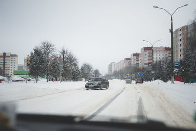 Cars on city street during winter