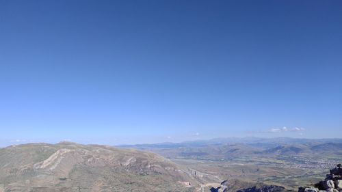 Scenic view of mountains against clear blue sky