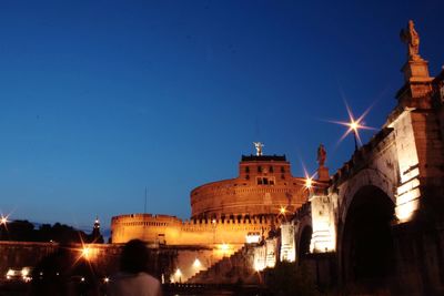 Low angle view of illuminated cathedral against sky at night