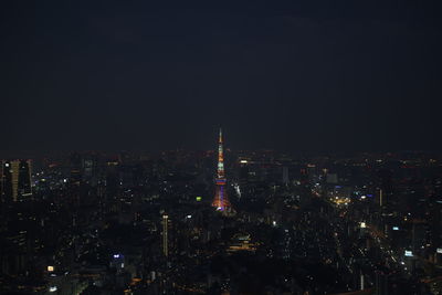 Illuminated cityscape against sky at night